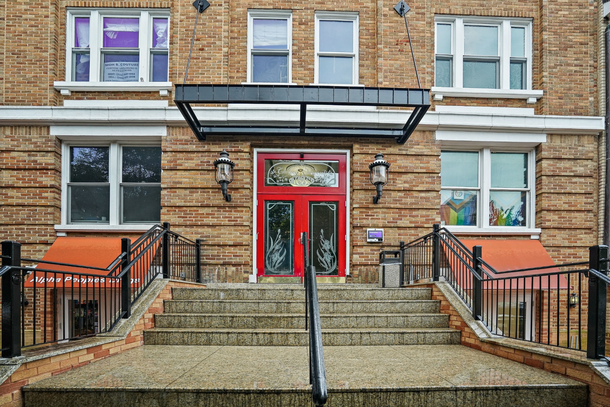 Awning, red entrance doors, and front steps at Chelsea Gardens